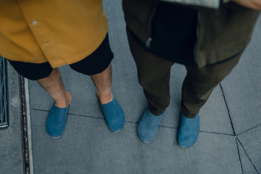A top down view of blue slippers.