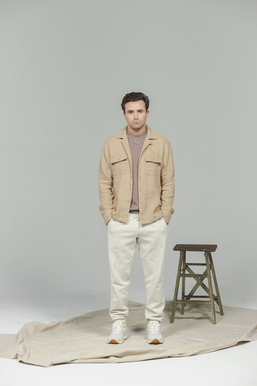 A man in a tan shirt and sweatpants.