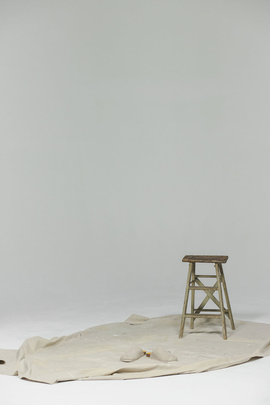 A empty shot with grey sandals on the ground.