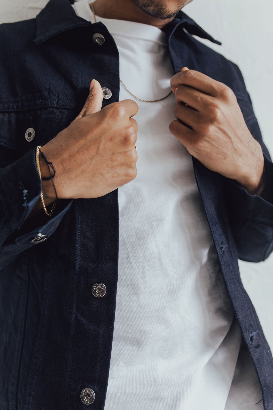 Closeup shot of a man wearing a 3sixteen Type 3s denim jacket