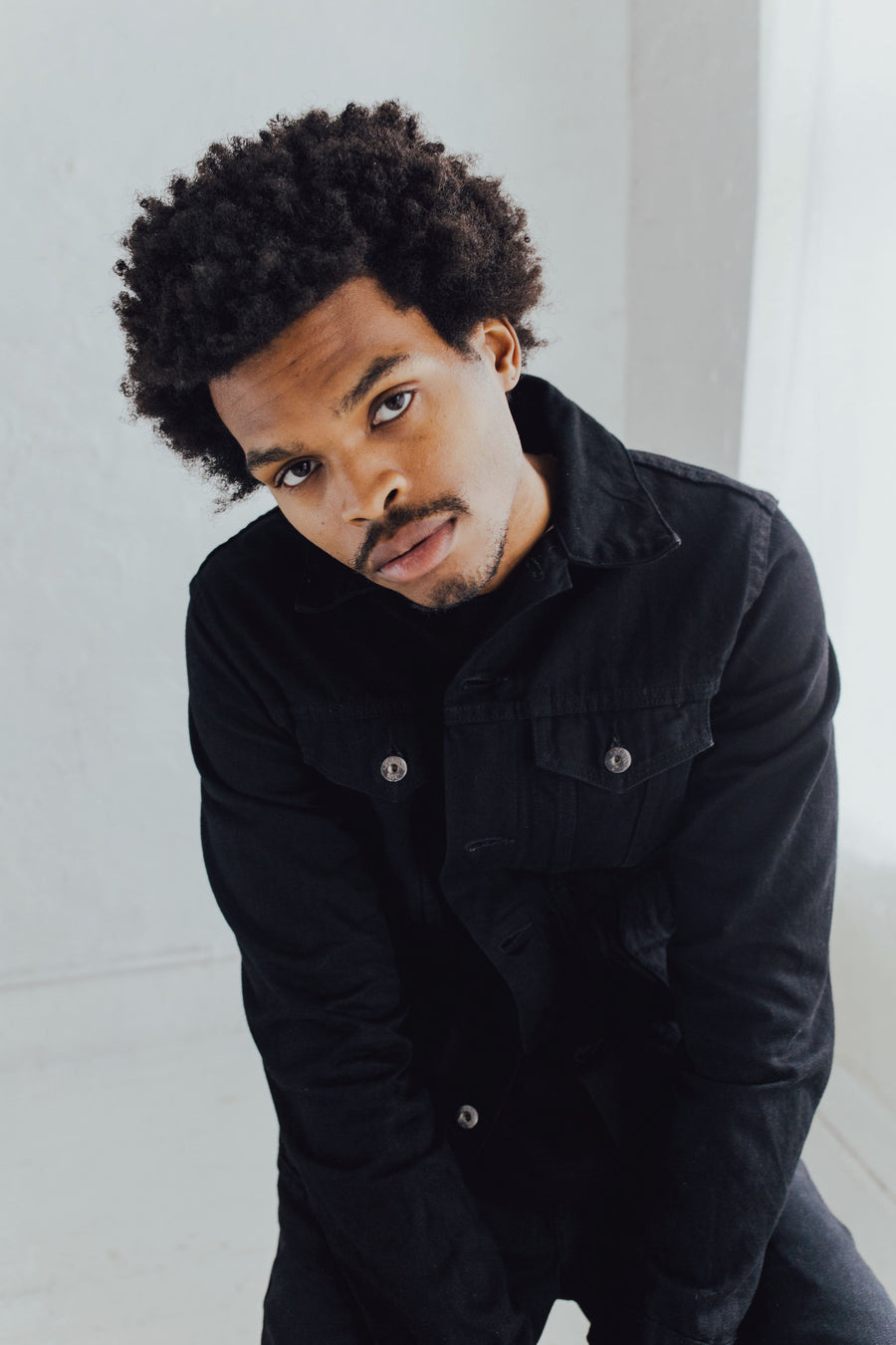 Portrait of a seated model wearing a 3sixteen Type 3s jacket