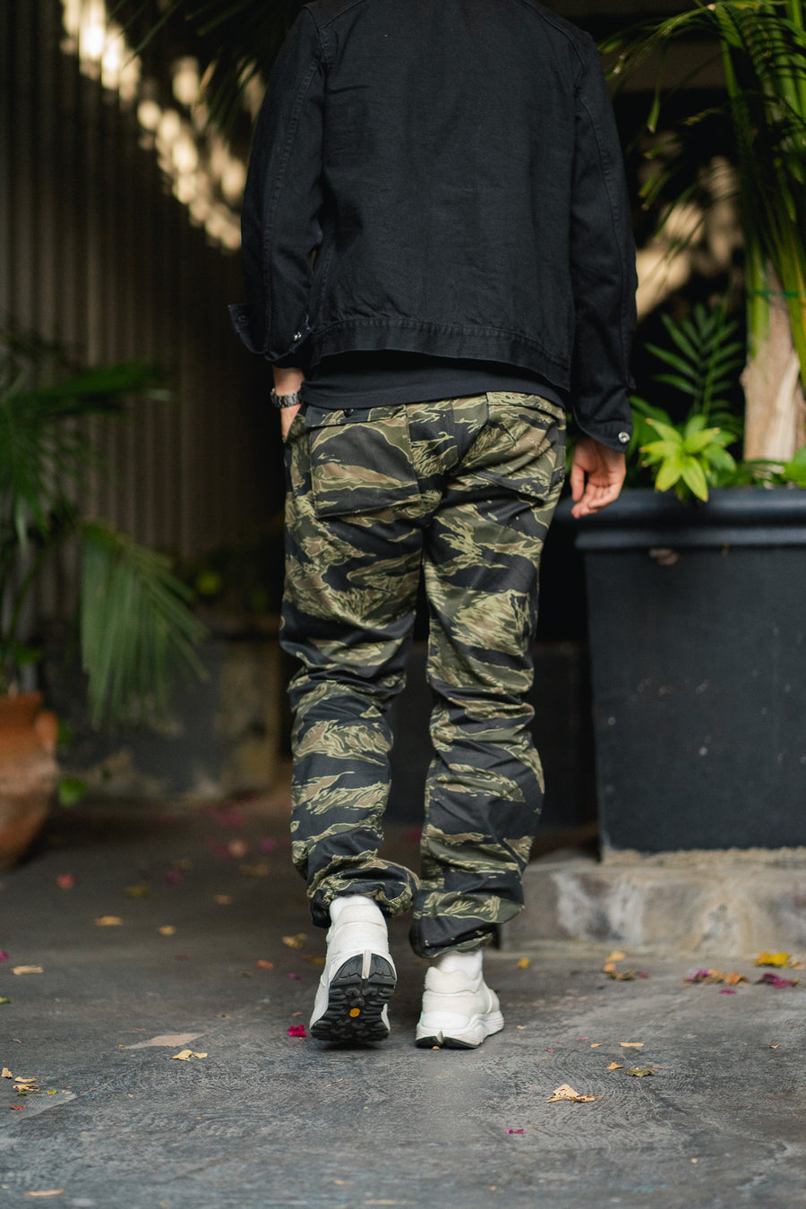 Man in camouflage pants walks away
