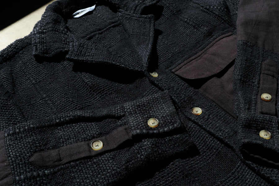 A detailed look at a highly textured black shirt.