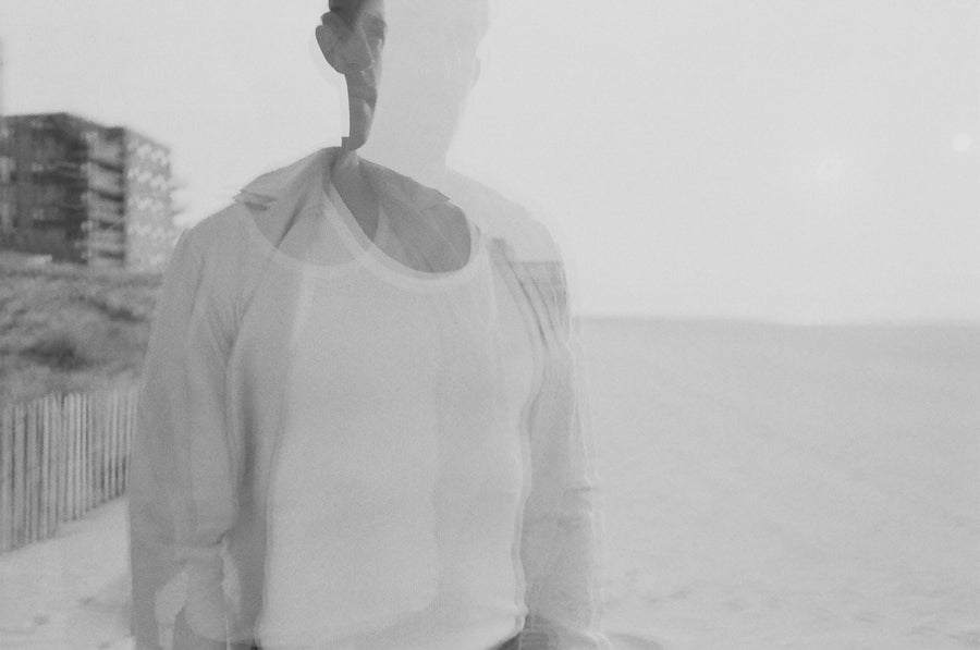 A blurry shot of a man in a button down shirt.