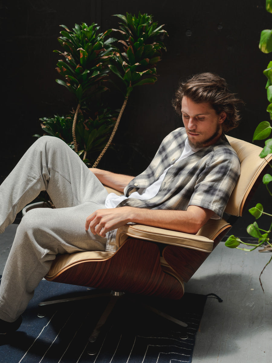 A man in a lounge chair leans back.