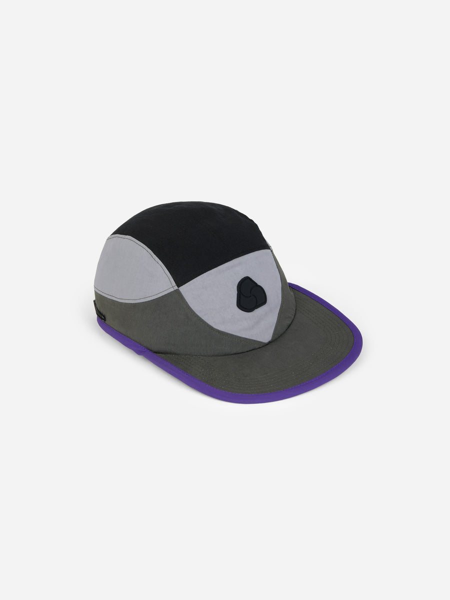 Multicolored cap with black, gray, and purple sections on a white background