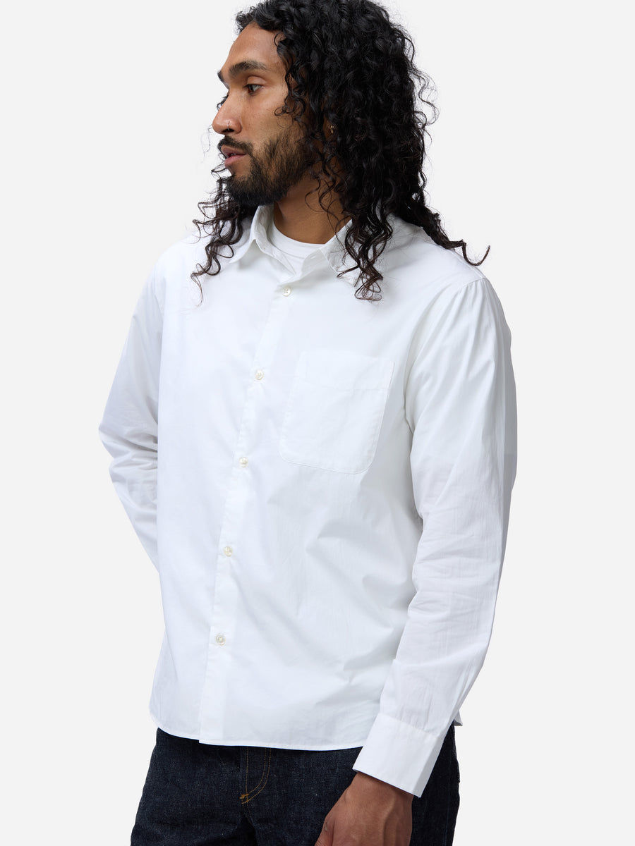 Man wearing a white button-up shirt against a white background