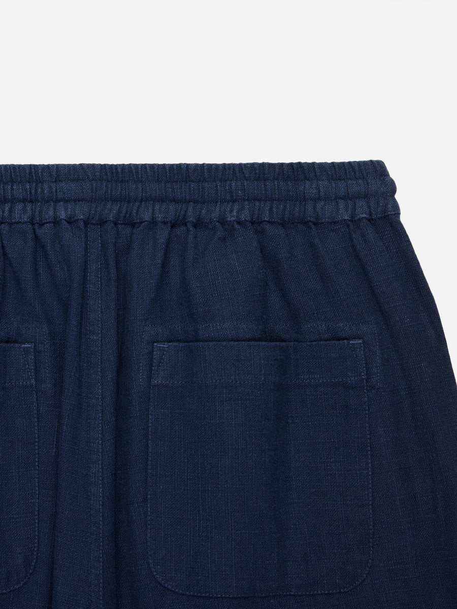 Navy blue shorts with a pocket on a light gray background