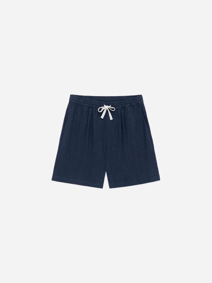 Navy shorts with a white drawstring on a grey background.