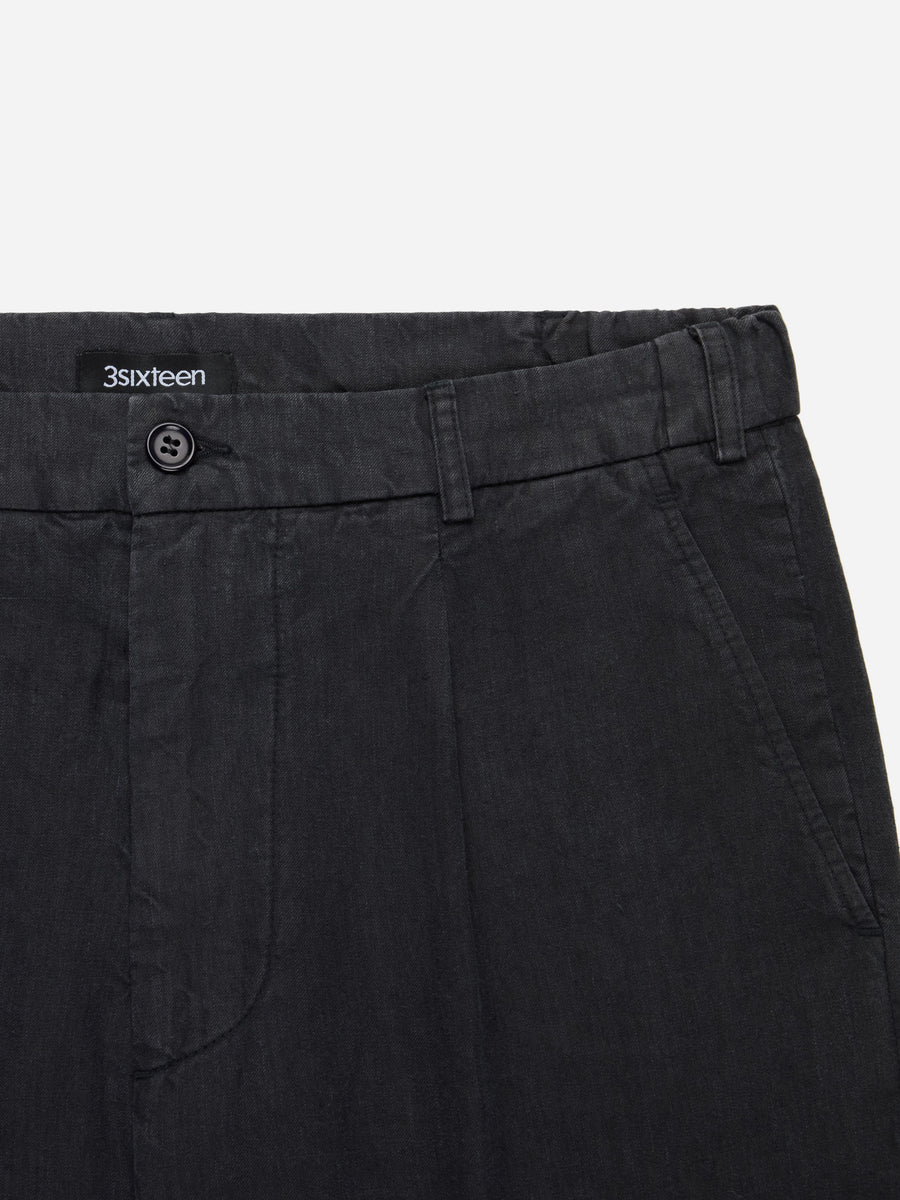 Black pants with a visible brand label on a white background