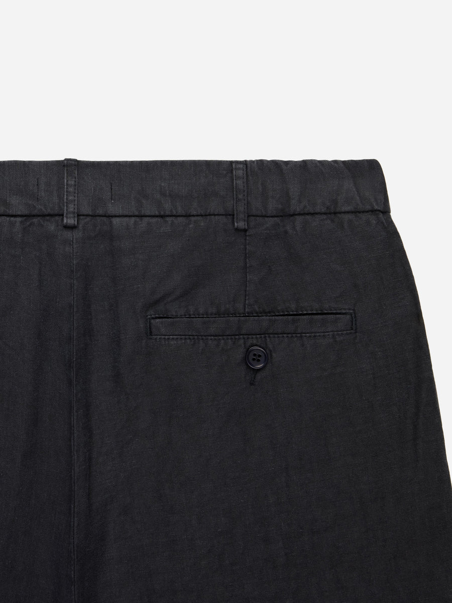 Black pants with a button on a light gray background
