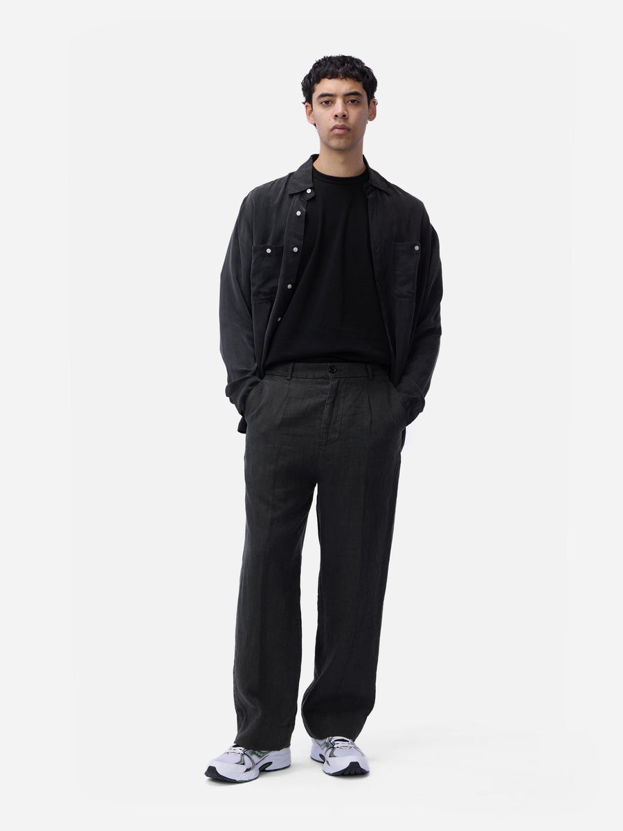 Man wearing a black outfit with a white background