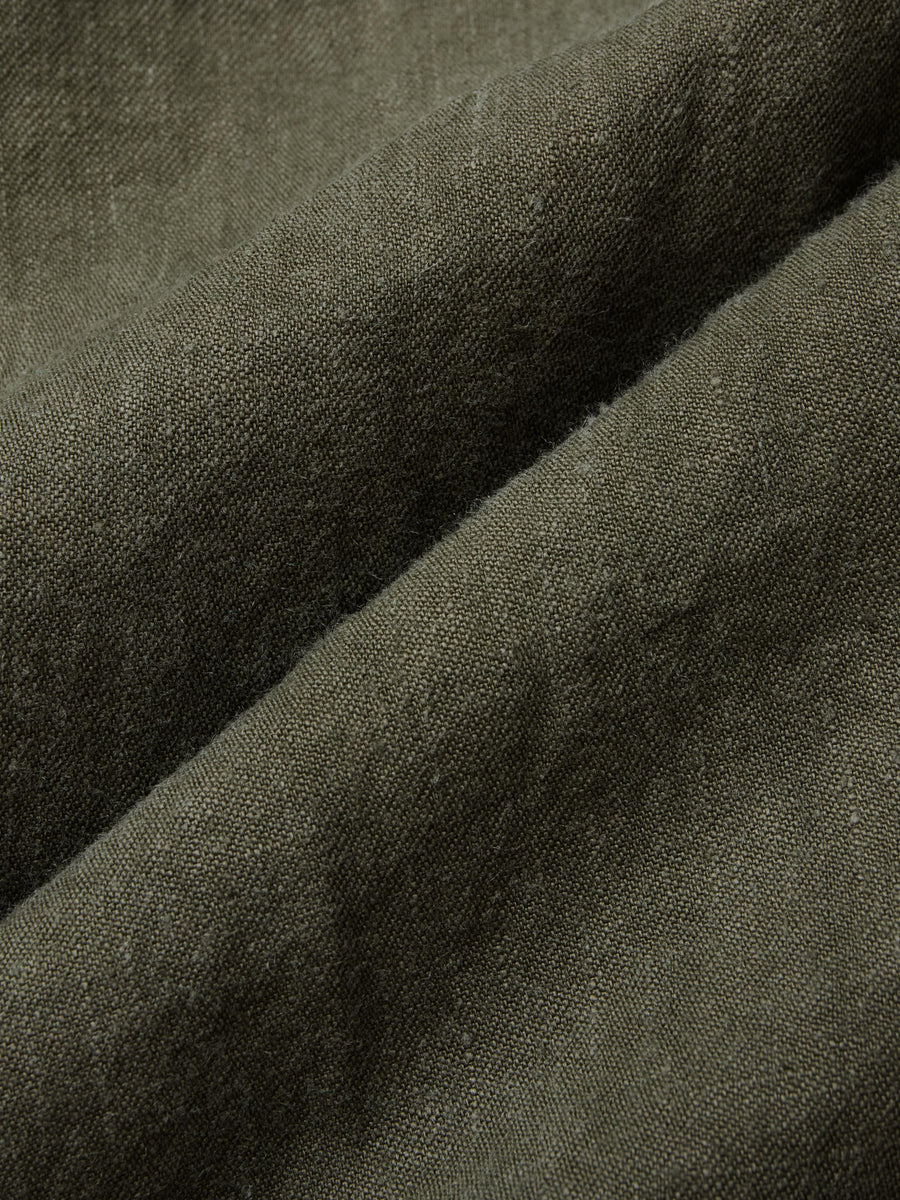 Close-up of dark green fabric with a textured pattern
