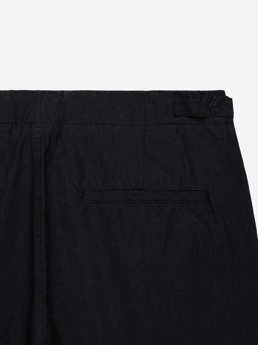 Close-up of black pants with a pocket on a white background