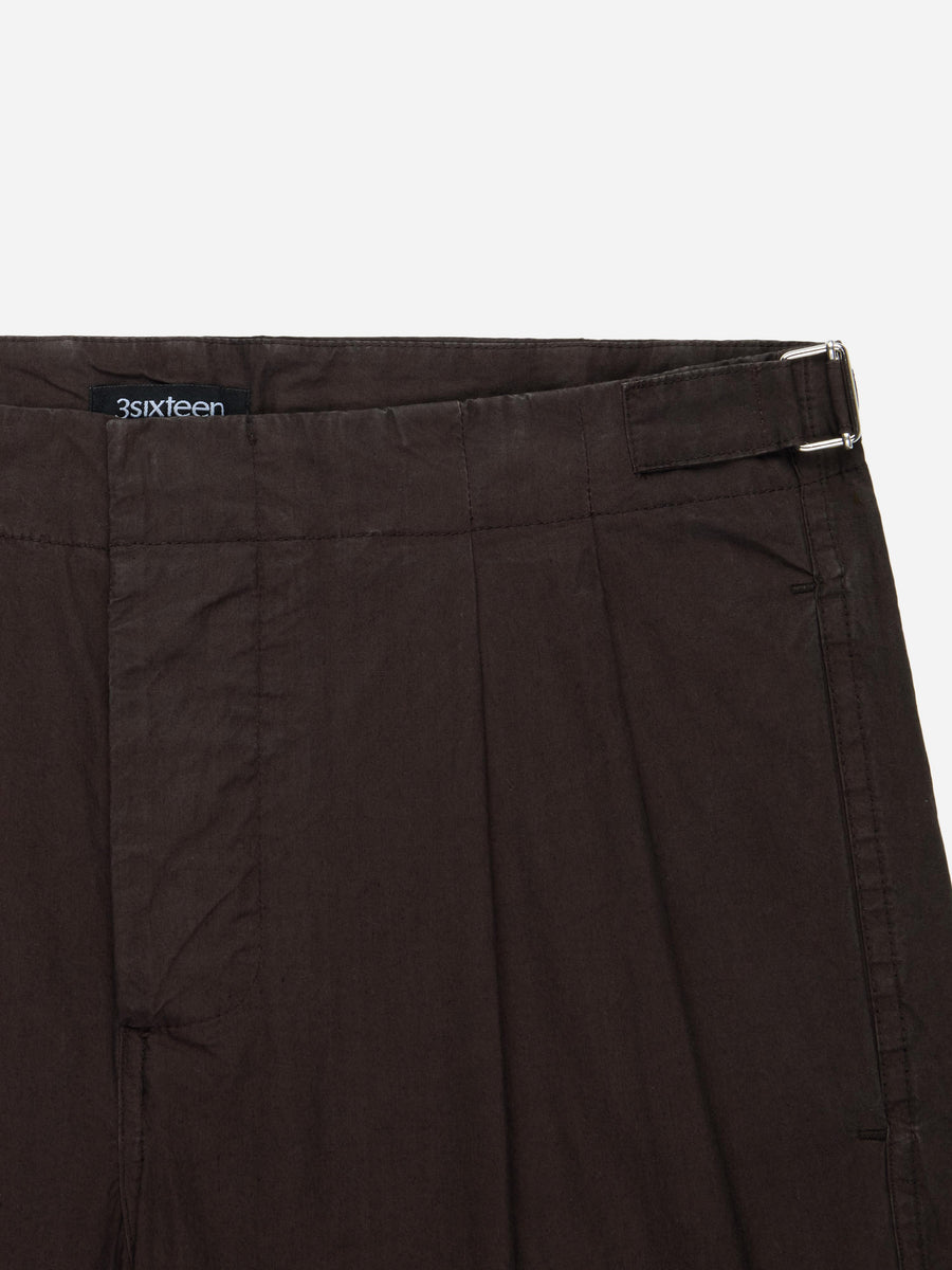 Brown pants with a visible brand label on a white background