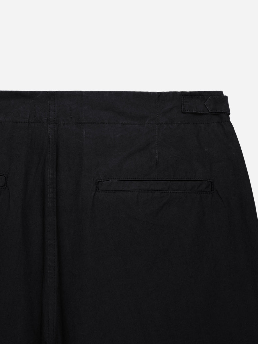 Close-up of black pants with a pocket on a white background