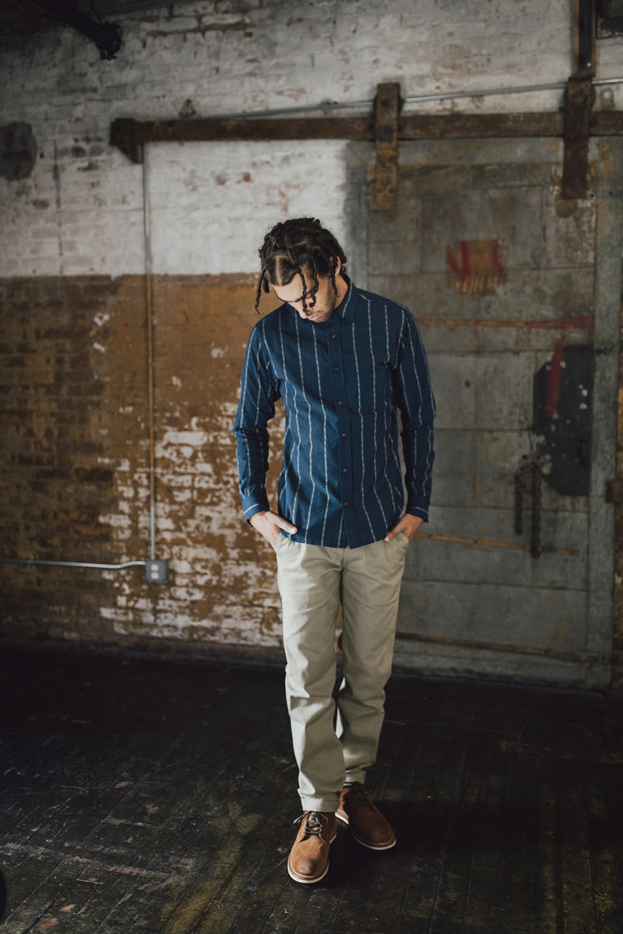 Man wearing navy stripe shirt.