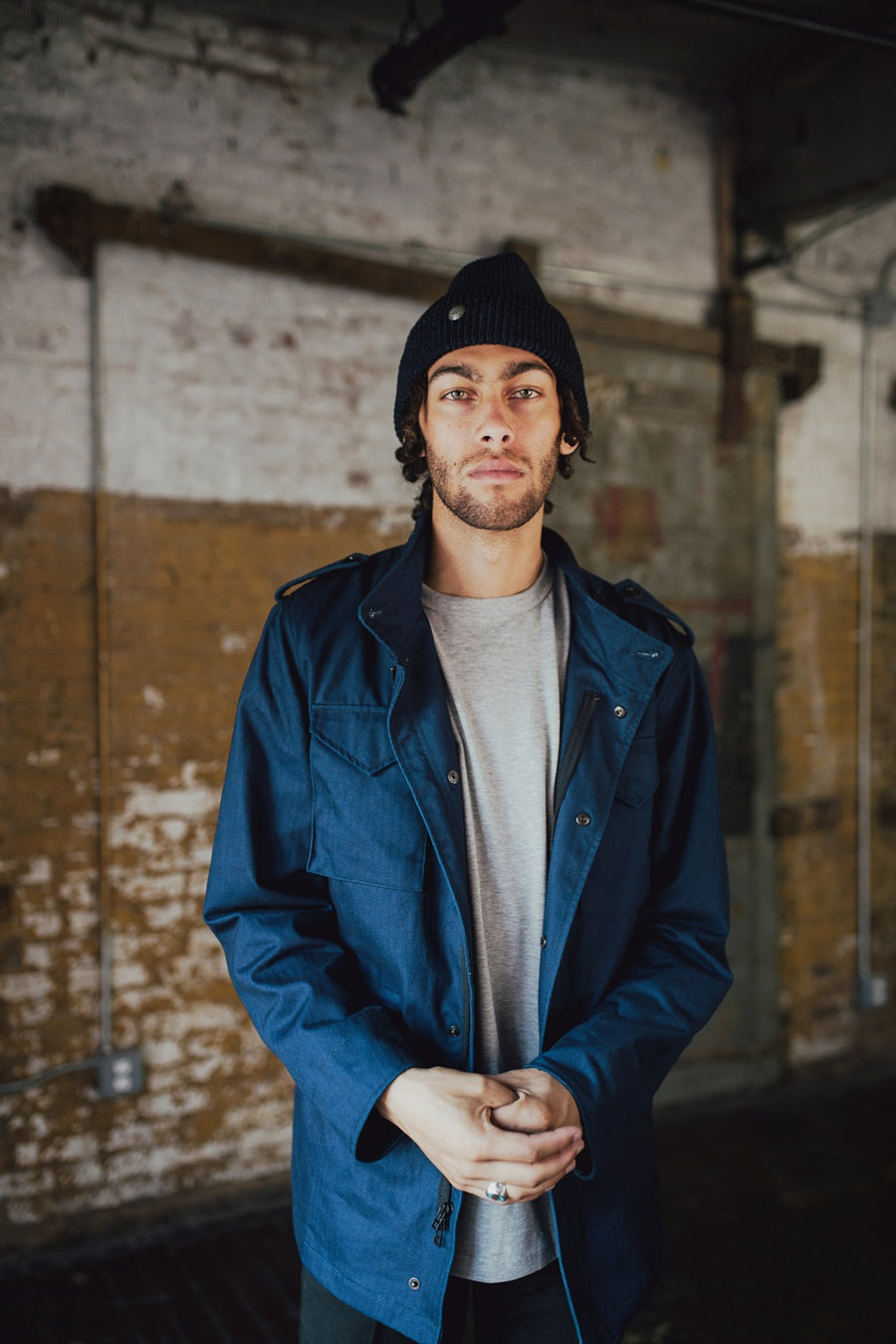 Man wearing navy jacket and beanie.