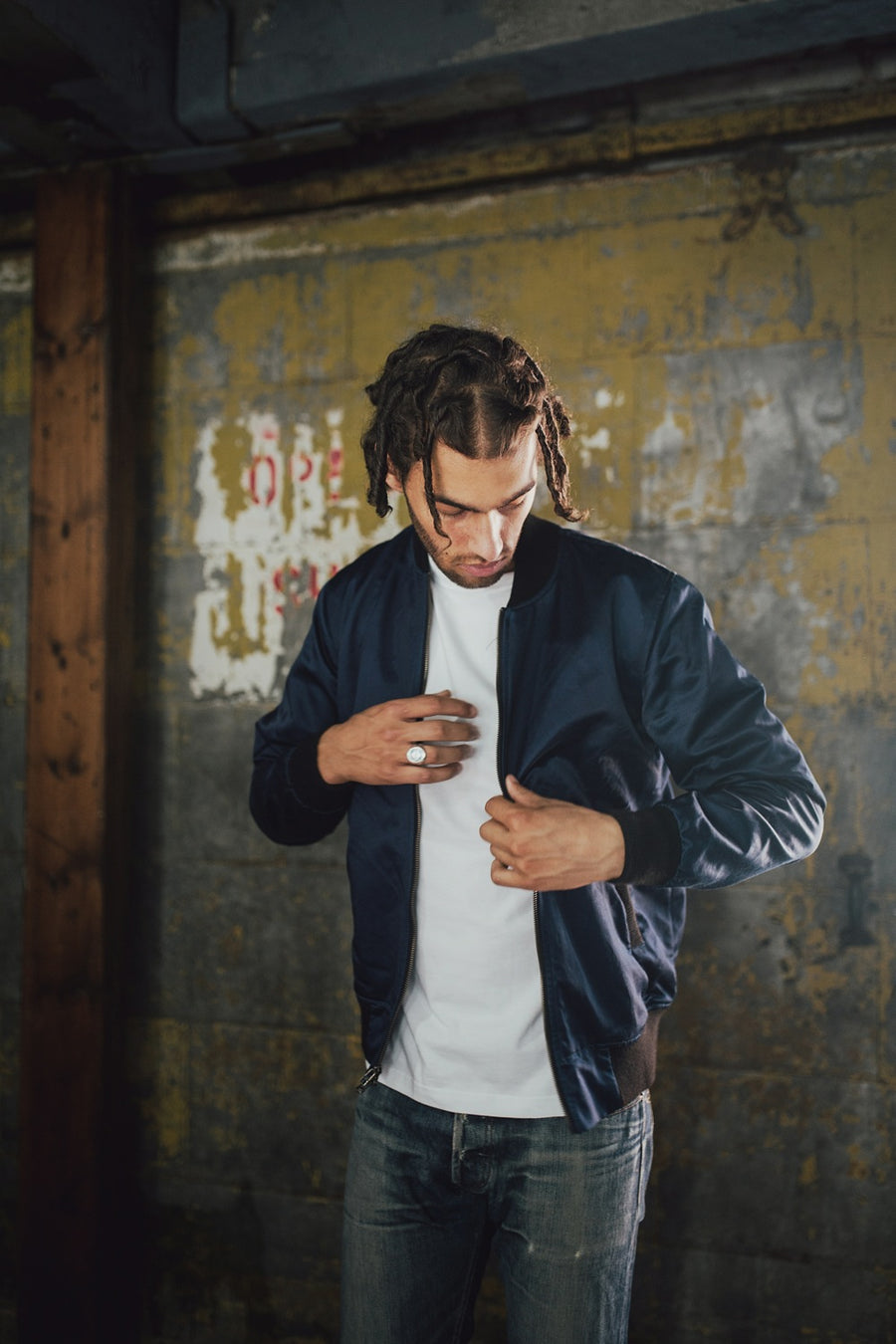 Man wearing stadium jacket.
