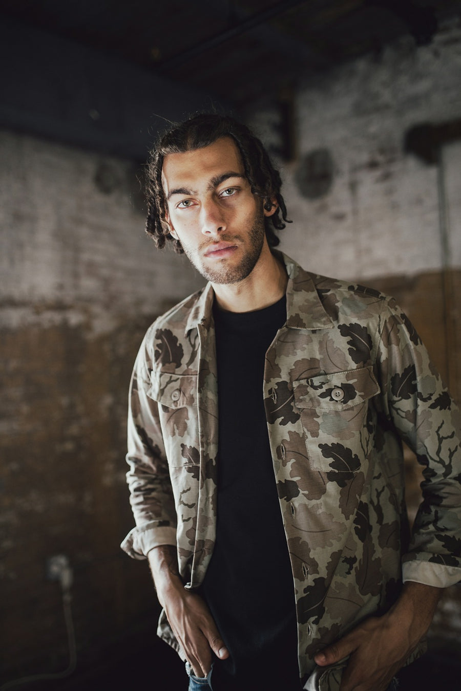 Man wearing camouflage shirt.