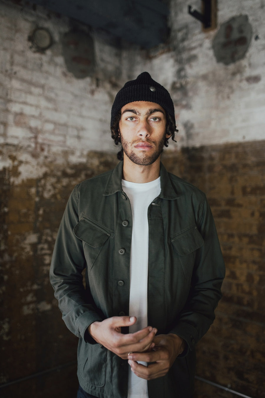 Man wearing beanie and BDU jacket.