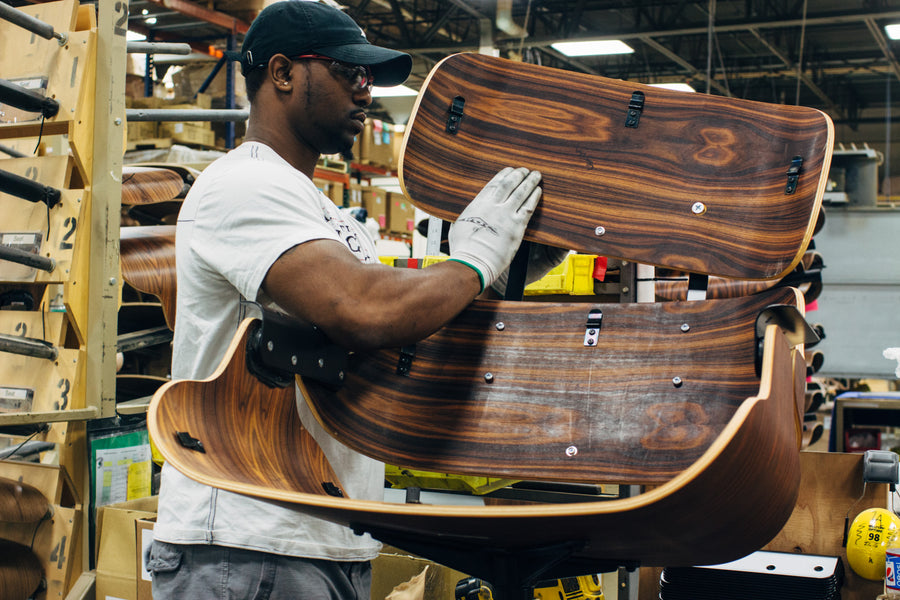 A man carefully assembles a lounge chair.