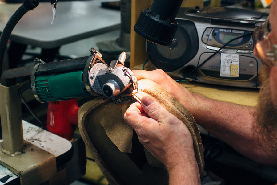 A man sews a cushion cover.