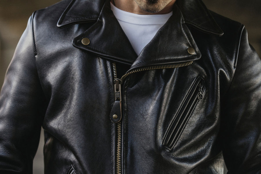 Front of asymmetrical school leather jacket on a model.