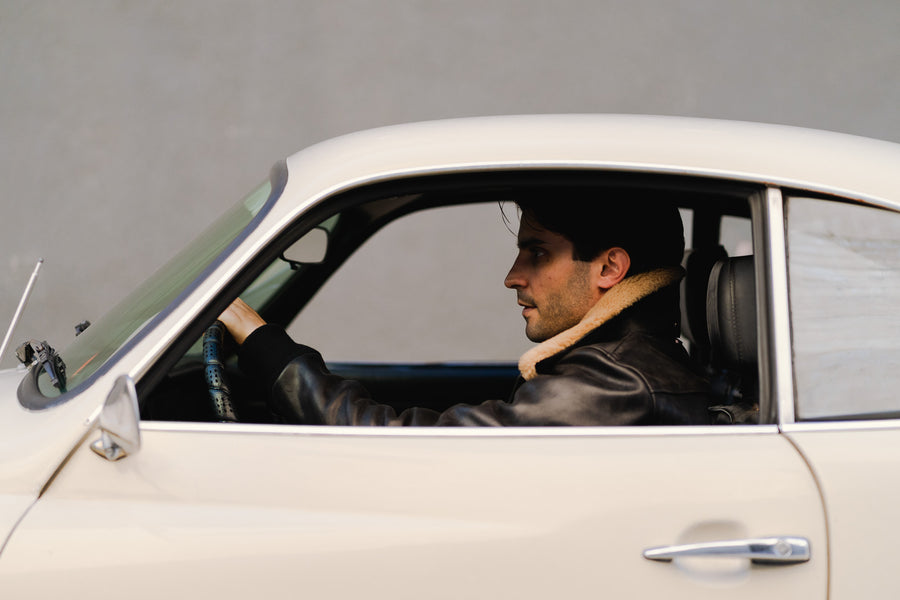 A side profile of the man in the leather jacket.