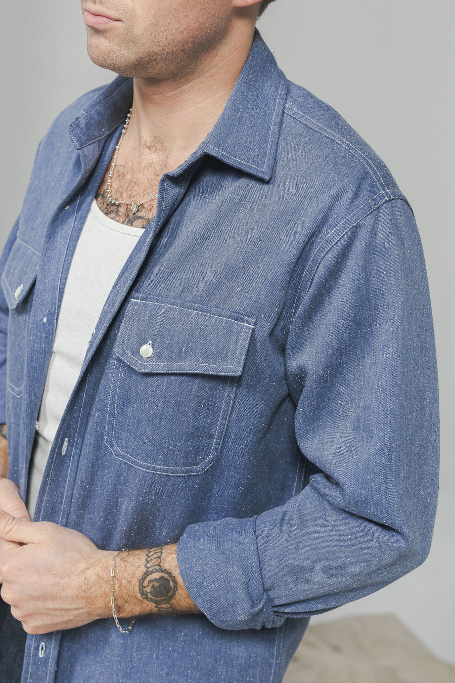 A man in a blue western shirt.