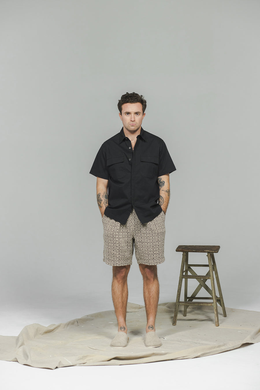 A man in a black shirt and black shorts.