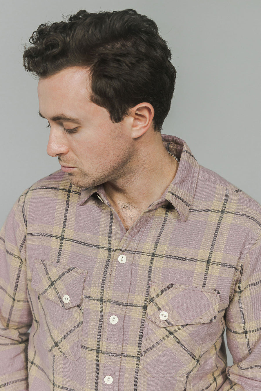 A portrait of a man in a pink flannel.