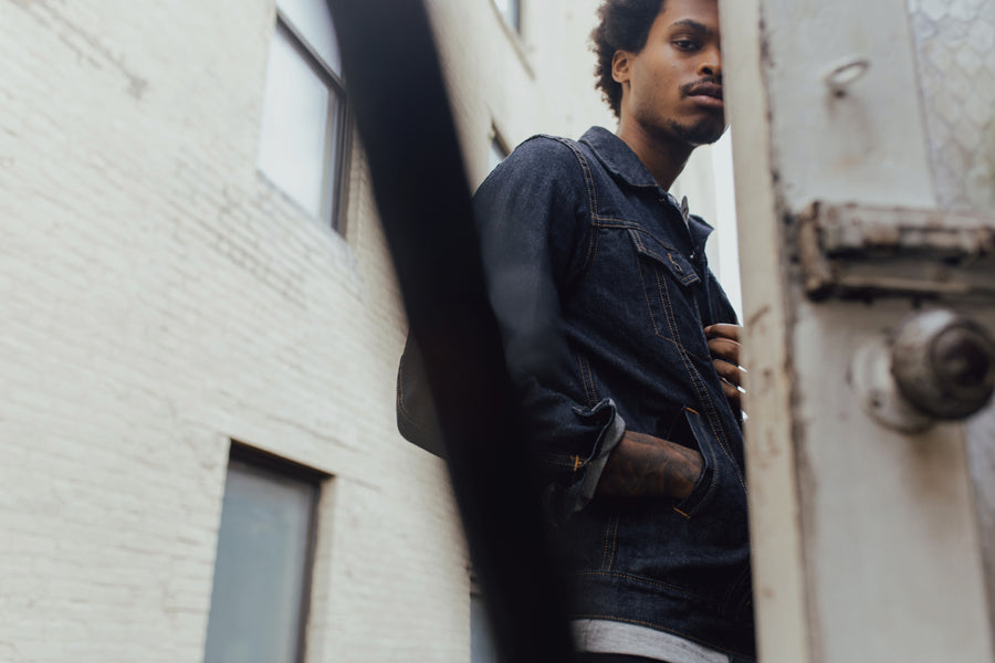 Man poses wearing a 3sixteen Type 3s denim jacket in raw indigo selvedge