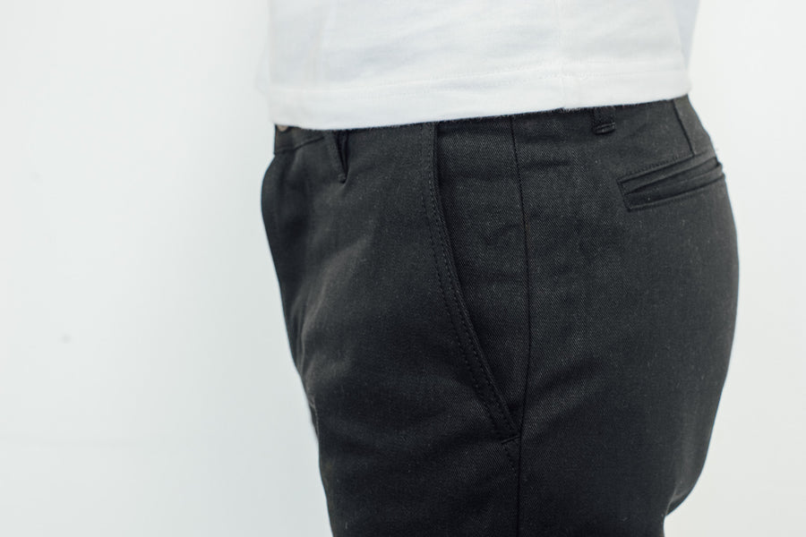Close up view of pocket on black chino.