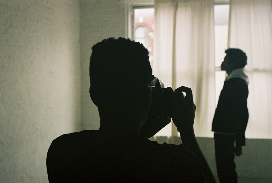 A man taking a portrait photo of another man