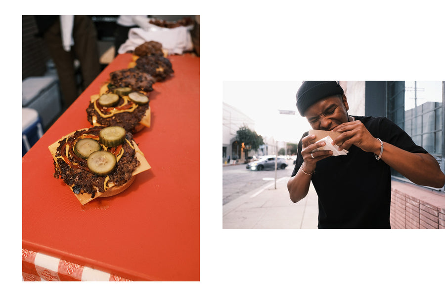 Finished grilled burgers and a man biting into one.