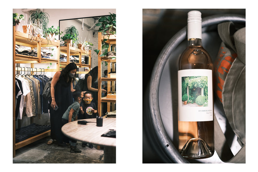A mother and two kids inside a store, and a bottle of wine.