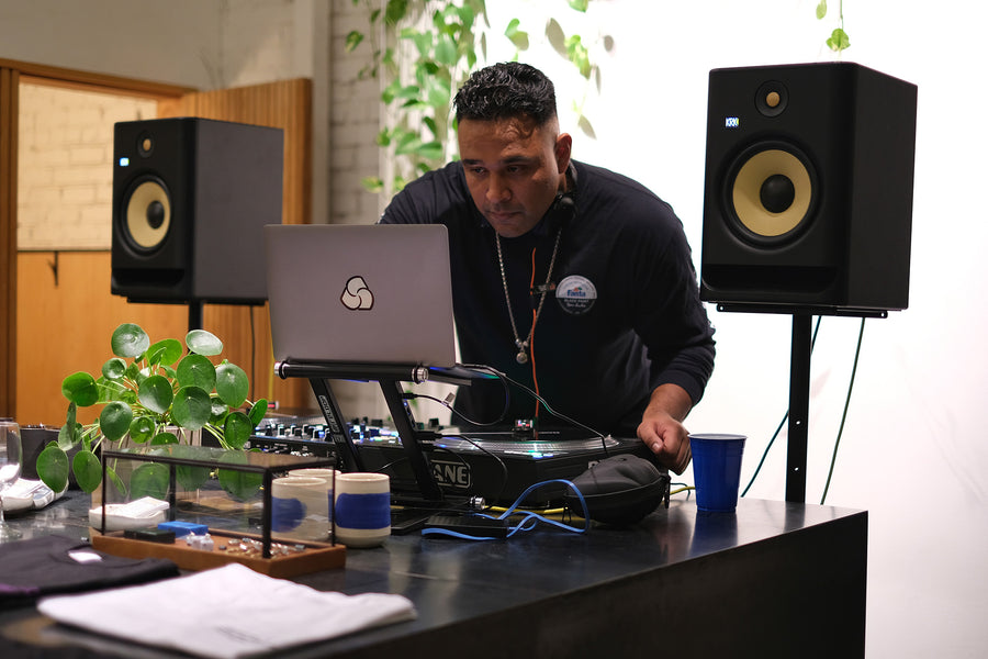 A DJ on the turntables mixing music.