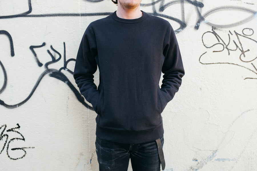 Shot of the black crewneck on Wesley.