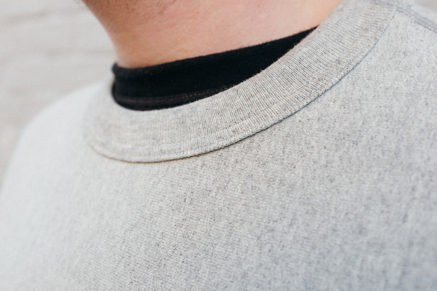 Close up shot of the rolled collar on the crewneck.