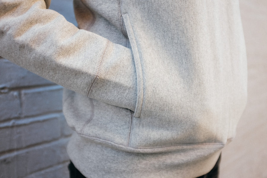 Close up shot of the hidden hand pocket near side gusset of the crewneck.