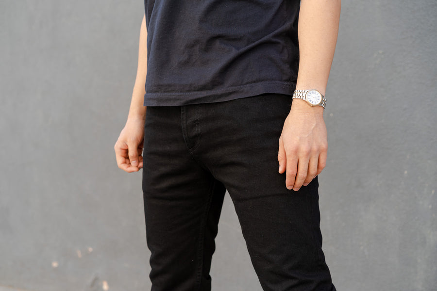 A close up shot of the top block of a pair of black jeans.