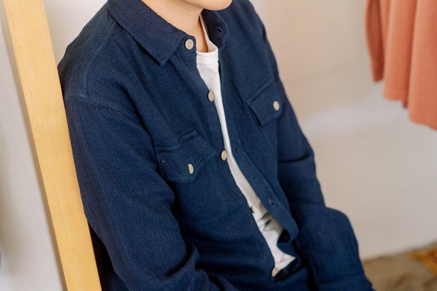 An up close look at a highly textured blue shirt.