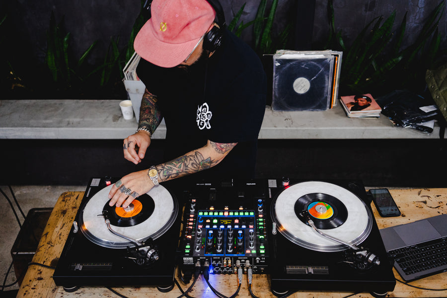 DJ Excel spins tunes for the guests on two turntables.