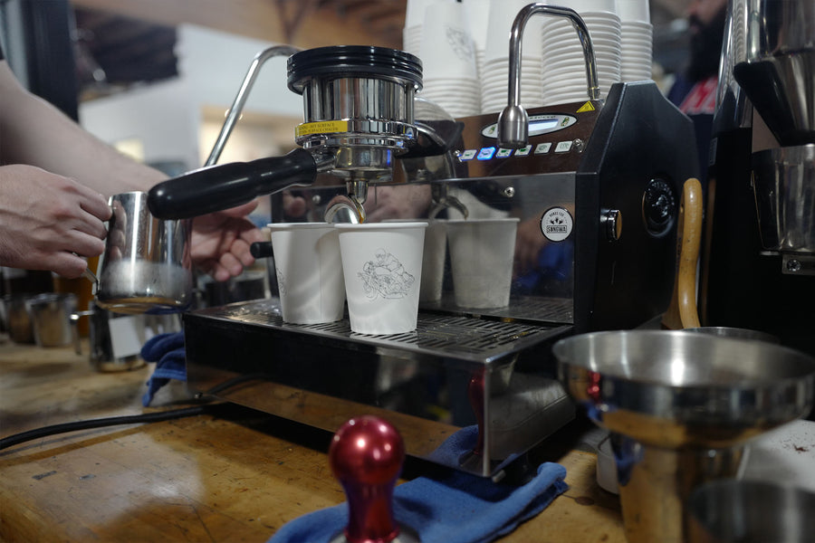 A closeup shot of the La Marzocco espresso machine pulling shots for customers.