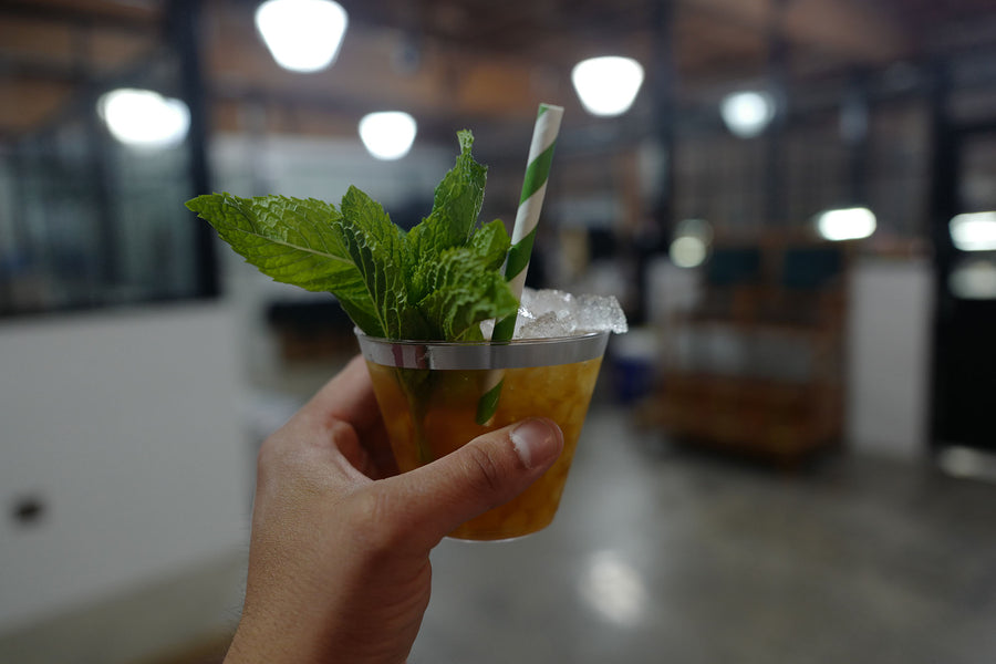 A cold mixed drink courtesy of Westward Whiskey, complete with fresh mint leaves garnishing the cup.