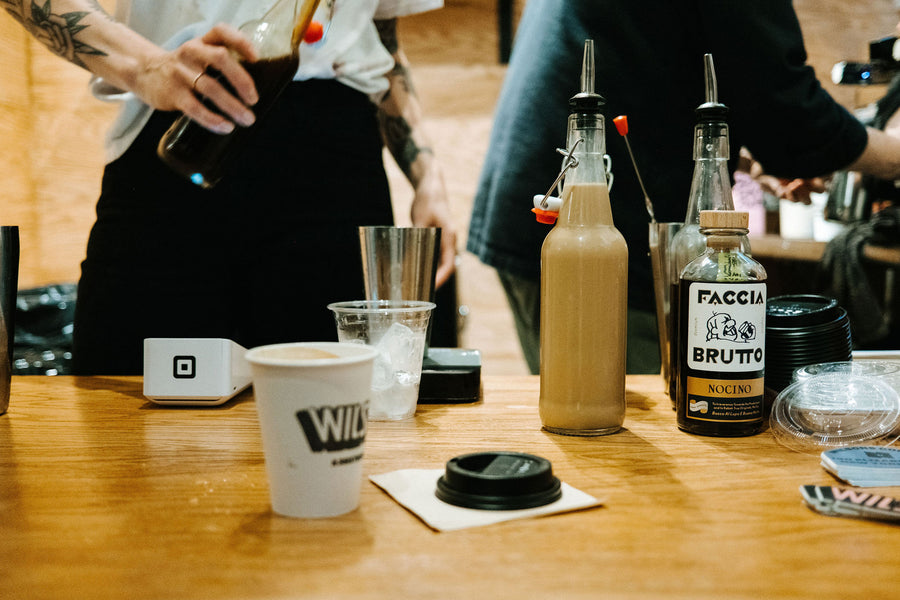A bunch of drink ingredients on a wooden counter.